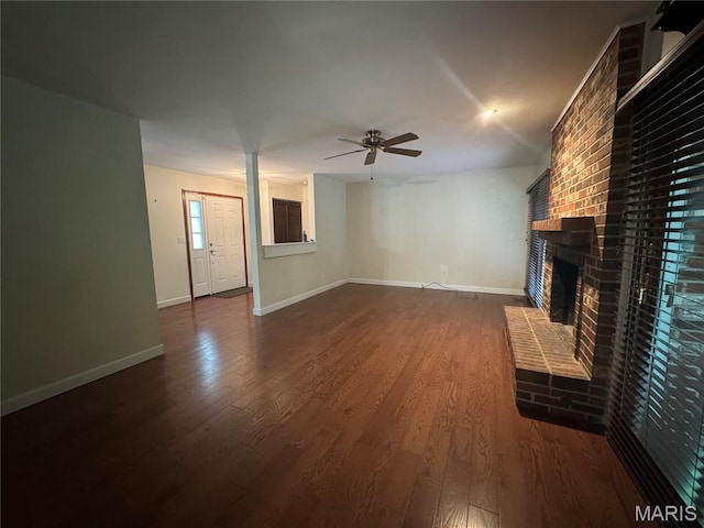 5810 White Pine Dr, Saint Louis, MO 63129 - unfurnished living room featuring ceiling fan, a fireplace, and dark wood-style floors