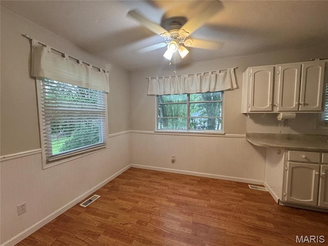 5810 White Pine Dr, Saint Louis, MO 63129 - unfurnished dining area featuring wood finished floors and ceiling fan