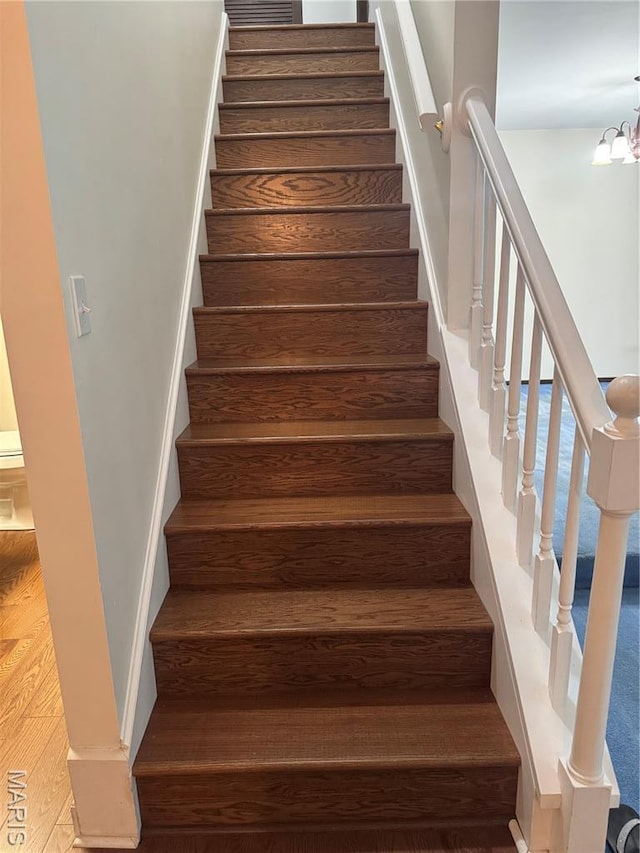 5810 White Pine Dr, Saint Louis, MO 63129 - staircase with a chandelier