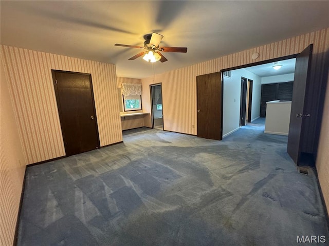 5810 White Pine Dr, Saint Louis, MO 63129 - spare room with radiator heating unit, wallpapered walls, a ceiling fan, and carpet flooring