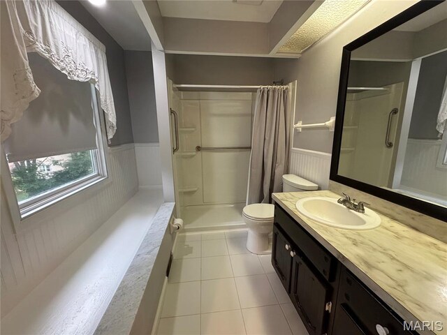 5810 White Pine Dr, Saint Louis, MO 63129 - bathroom with wainscoting, a shower stall, vanity, and tile patterned flooring