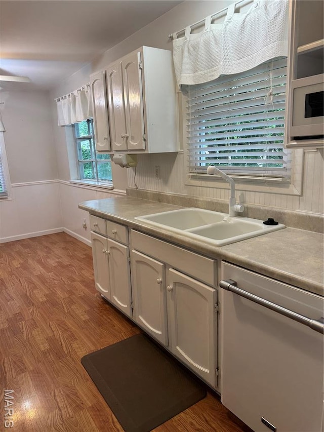 5810 White Pine Dr, Saint Louis, MO 63129 - kitchen with white dishwasher, light countertops, wood finished floors, and white cabinetry