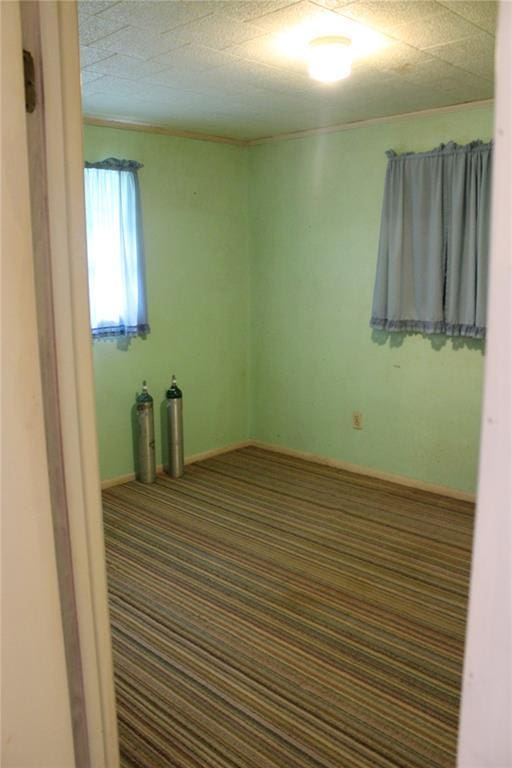 carpeted empty room featuring ornamental molding