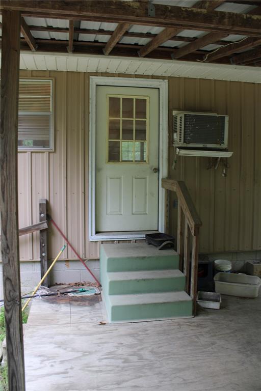 entrance to property featuring a wall mounted AC
