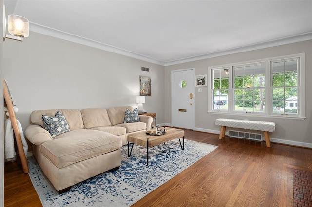 living room with ornamental molding, baseboards, and wood finished floors