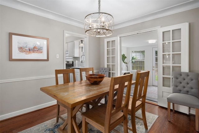 dining room with dark wood finished floors, a chandelier, baseboards, and french doors