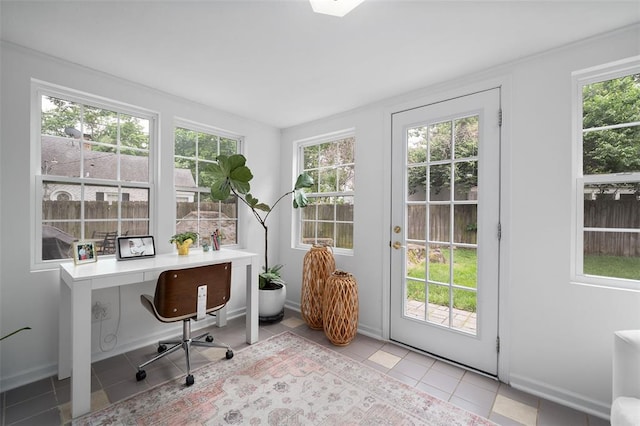 office area featuring light tile patterned floors, plenty of natural light, and baseboards