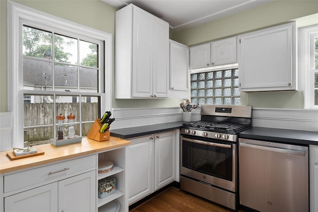 kitchen with stainless steel appliances, white cabinetry, and healthy amount of natural light