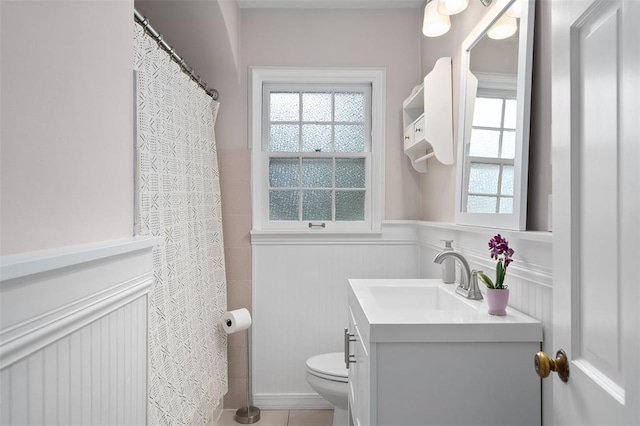 full bath featuring a wainscoted wall, vanity, and toilet