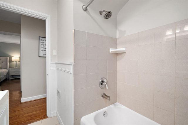 bathroom featuring shower / bath combination, wood finished floors, and connected bathroom