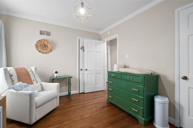 sitting room featuring ornamental molding, dark wood finished floors, and baseboards