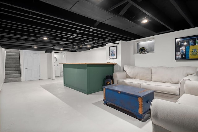 finished basement with stairs and a dry bar