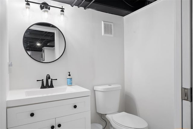 half bathroom featuring toilet and vanity