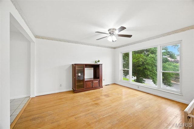 2649 Georgia Dr, Arnold, MO 63010 - unfurnished living room featuring ceiling fan, light wood-style flooring, and crown molding