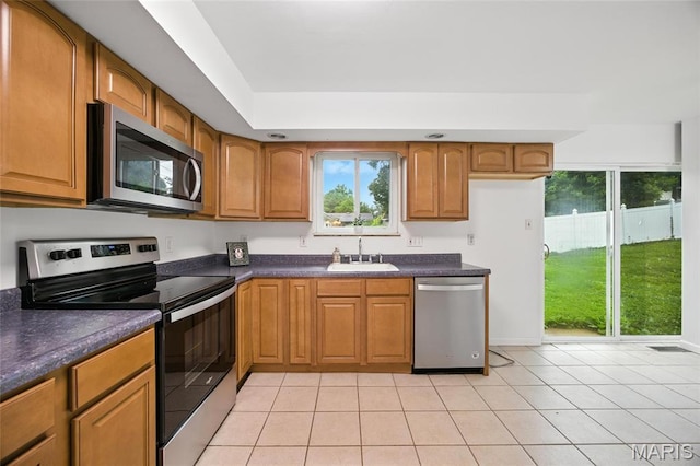 2649 Georgia Dr, Arnold, MO 63010 - kitchen with stainless steel appliances, dark countertops, and brown cabinets