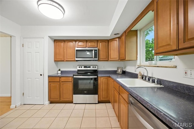 2649 Georgia Dr, Arnold, MO 63010 - kitchen featuring appliances with stainless steel finishes, brown cabinets, and dark countertops