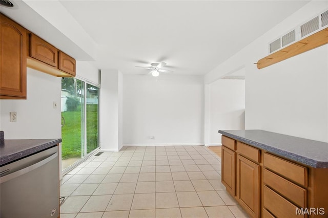 2649 Georgia Dr, Arnold, MO 63010 - kitchen with dishwasher, dark countertops, a ceiling fan, brown cabinets, and light tile patterned flooring