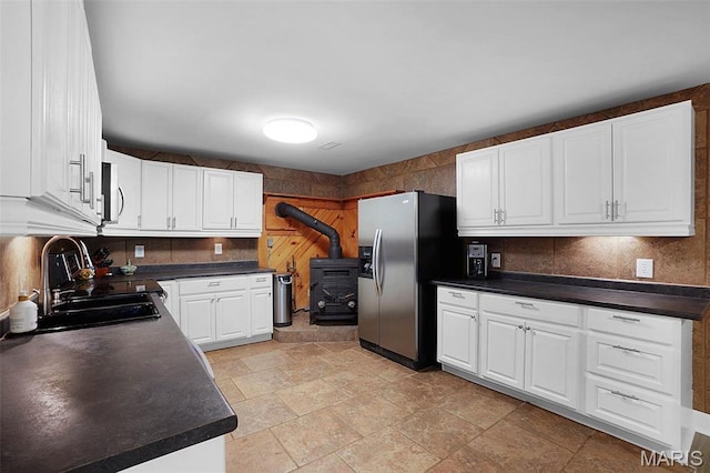 14938 Pike 139, Bowling Green, MO 63334 - kitchen with appliances with stainless steel finishes, a sink, dark countertops, and backsplash