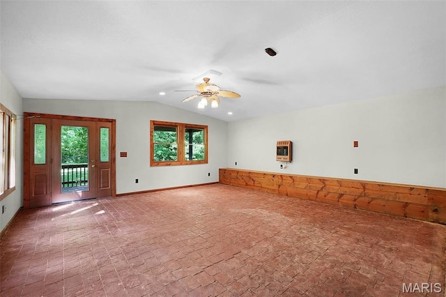 14938 Pike 139, Bowling Green, MO 63334 - unfurnished living room featuring lofted ceiling, heating unit, a ceiling fan, plenty of natural light, and baseboards