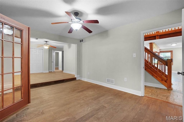 14938 Pike 139, Bowling Green, MO 63334 - spare room with wood finished floors, a ceiling fan, baseboards, and stairway
