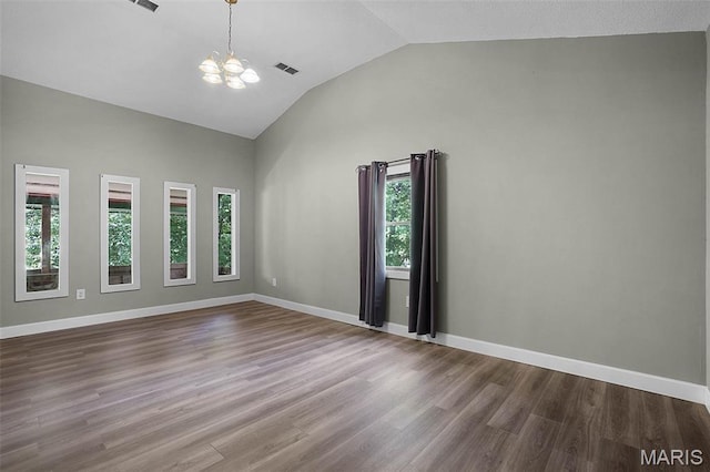 14938 Pike 139, Bowling Green, MO 63334 - spare room featuring a chandelier, dark wood-style flooring, baseboards, and high vaulted ceiling
