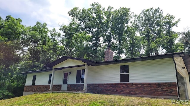 8708 Canyon Ln, Dittmer, MO 63023 - ranch-style home featuring brick siding, a front lawn, a chimney, and covered porch