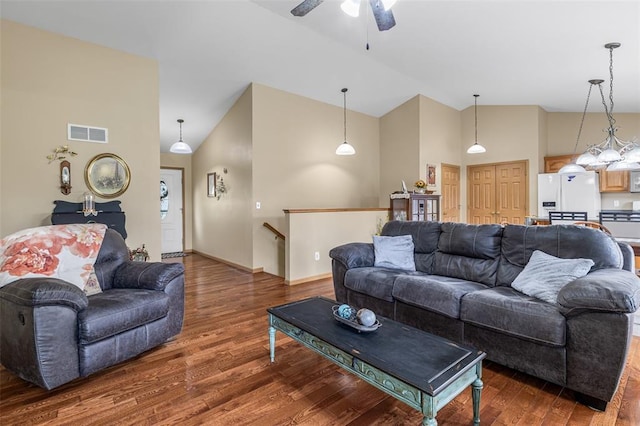 living room with wood finished floors, ceiling fan, and high vaulted ceiling