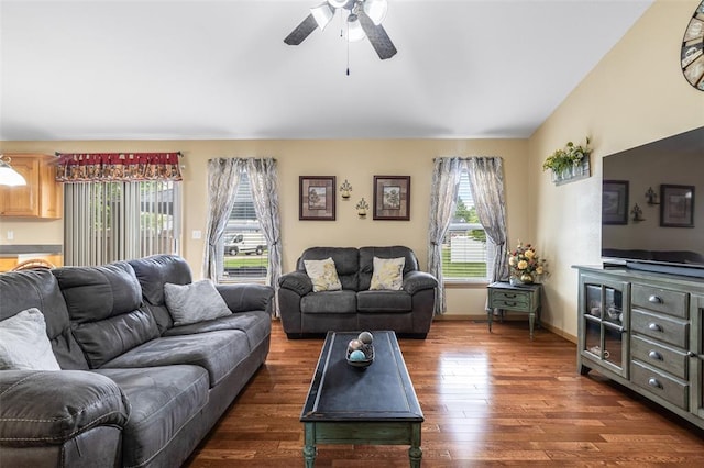 living room with plenty of natural light, dark wood-style floors, ceiling fan, and lofted ceiling