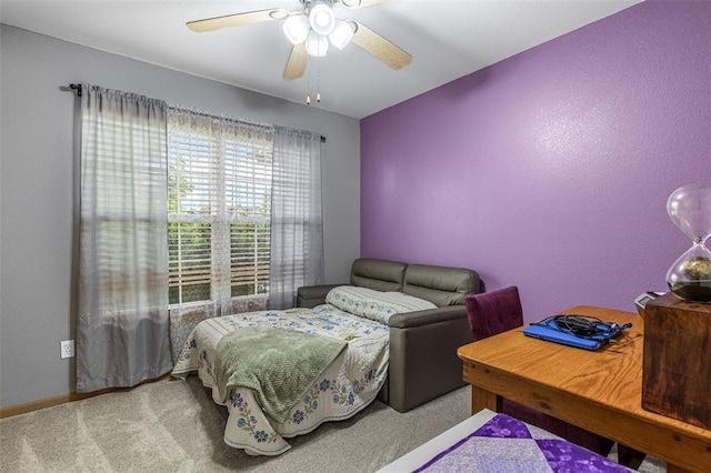 carpeted bedroom with ceiling fan and baseboards