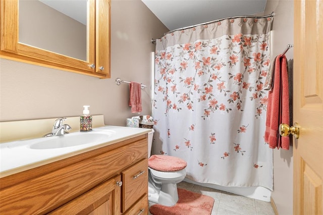 bathroom featuring toilet, tile patterned floors, and vanity