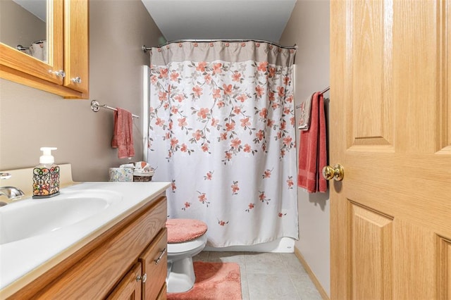 bathroom with toilet, vanity, tile patterned floors, and a shower with shower curtain