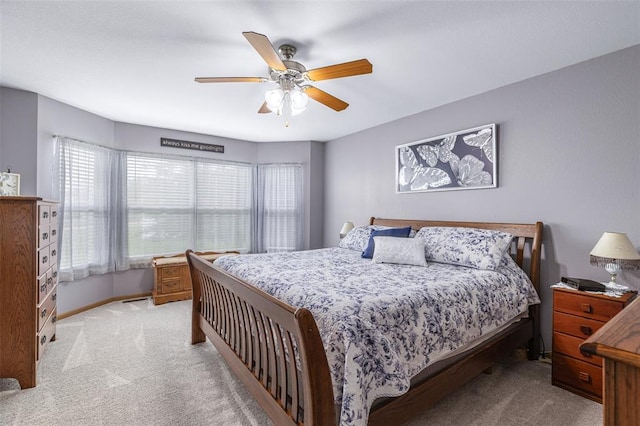 bedroom featuring light carpet, ceiling fan, and baseboards