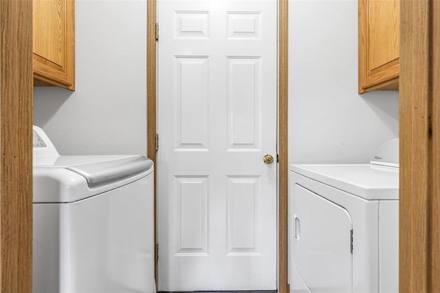laundry room featuring cabinet space and separate washer and dryer