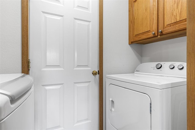 washroom featuring cabinet space and independent washer and dryer