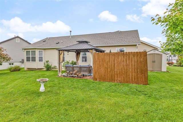 back of house with a gazebo, a storage unit, an outdoor structure, and roof with shingles
