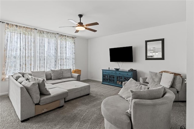 carpeted living room featuring ceiling fan and baseboards