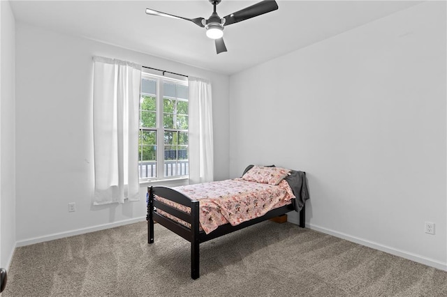 carpeted bedroom with baseboards and ceiling fan