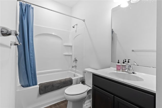 bathroom featuring shower / bath combo with shower curtain, toilet, vanity, and wood finished floors