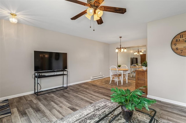 10003 Sakura Dr Unit B, Concord Township, MO 63128 - living area featuring baseboard heating, ceiling fan, wood finished floors, a chandelier, and baseboards