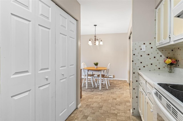 10003 Sakura Dr Unit B, Concord Township, MO 63128 - kitchen featuring white cabinets, a chandelier, light countertops, decorative light fixtures, and white electric range