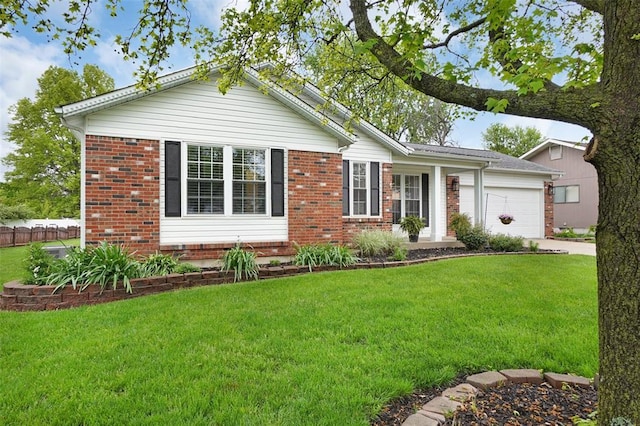 ranch-style house with a garage, brick siding, a front yard, and driveway