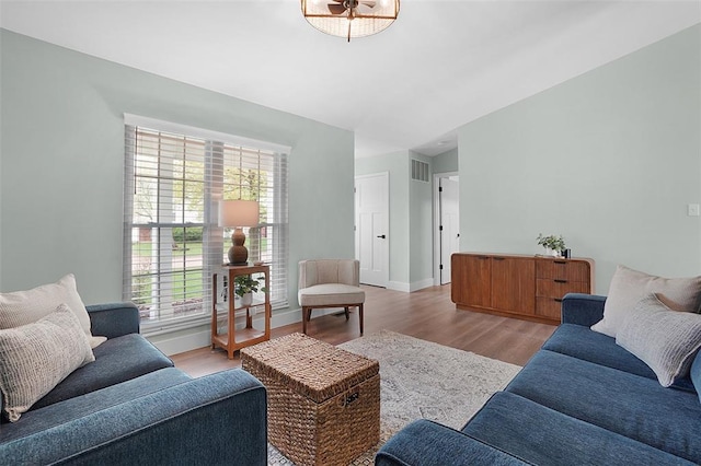 living area with light wood finished floors and baseboards