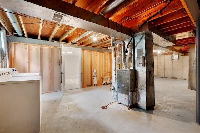 unfinished below grade area with independent washer and dryer and heating unit