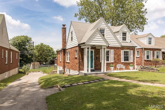 2235 Brown Rd, Overland, MO 63114 - view of front of house with brick siding, asphalt driveway, and a chimney