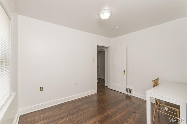 2235 Brown Rd, Overland, MO 63114 - unfurnished office featuring dark wood-type flooring, arched walkways, and plenty of natural light