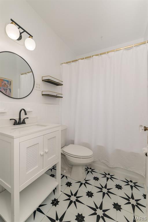 2235 Brown Rd, Overland, MO 63114 - full bathroom featuring vanity, tile patterned floors, and curtained shower