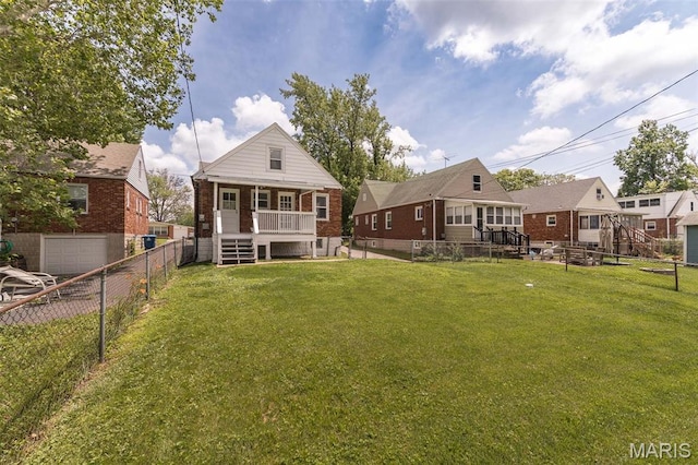 2235 Brown Rd, Overland, MO 63114 - back of property with covered porch, brick siding, and a fenced backyard