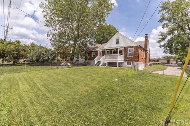 2235 Brown Rd, Overland, MO 63114 - back of property with a chimney, brick siding, a fenced backyard, and stairway