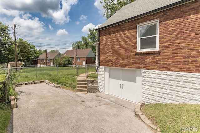 2235 Brown Rd, Overland, MO 63114 - view of property exterior with brick siding and a patio area