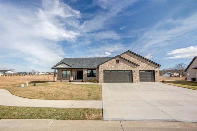 view of front of house with an attached garage, a front lawn, driveway, and brick siding